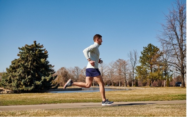 Homme faisant une course au soleil dans un parc