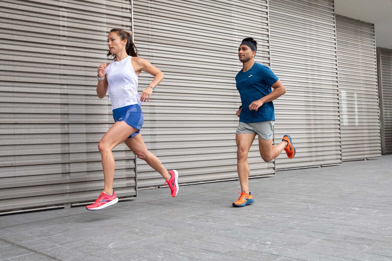 Two models wearing Brooks apparel and shoes running