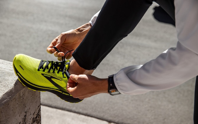 A runner tying their shoes