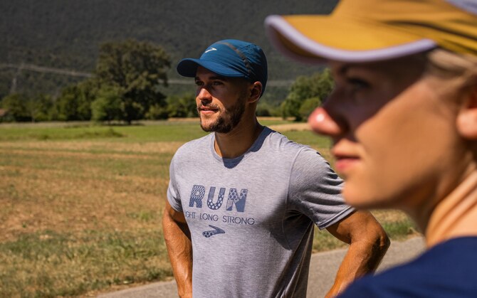 Two runners wearing a cap
