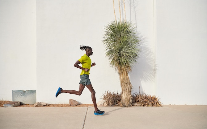 A runner with a white wall in the background.