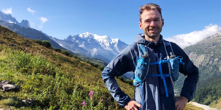 Man with trail running gear with mountain landscape in background