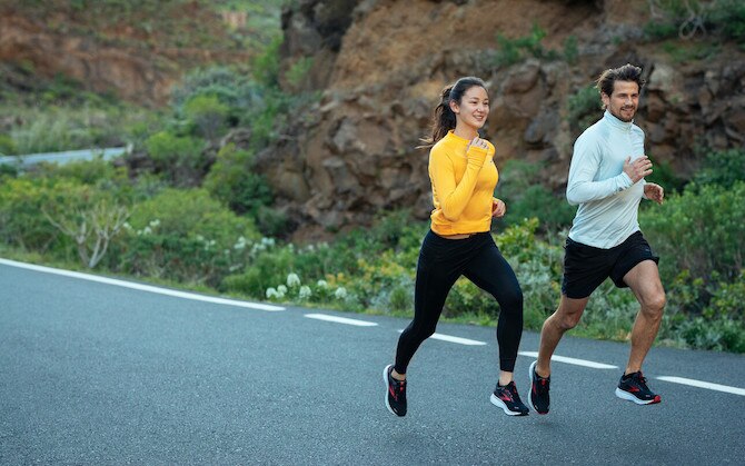Two people running on aroad