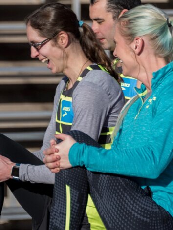 Coleen smiling while stretching before a run