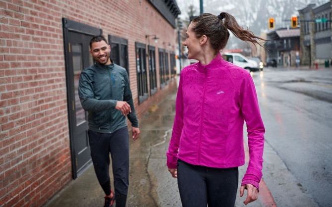 Two runners walking down a street