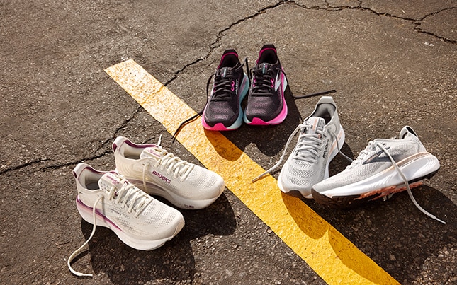 three pairs of the Brooks Adrenaline GTS 25 running shoes laid on concrete