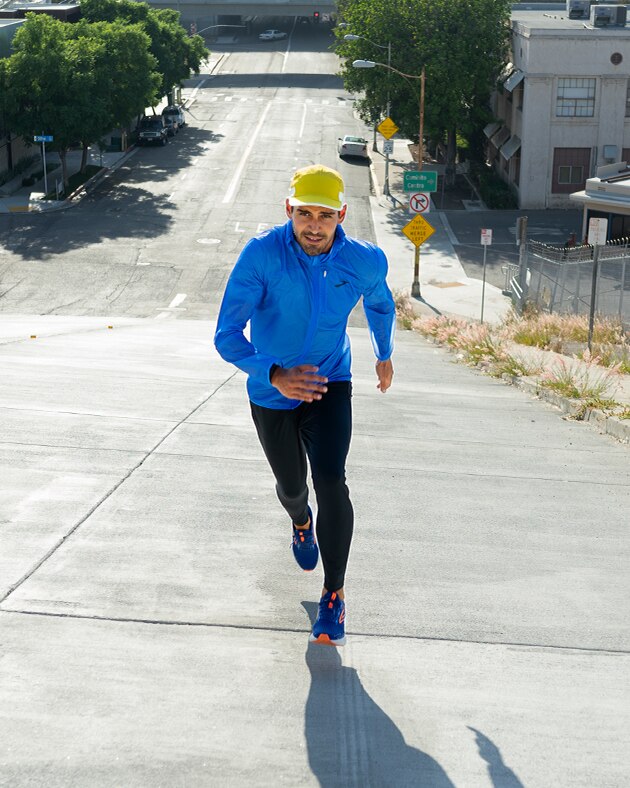 Man running uphill on a city street