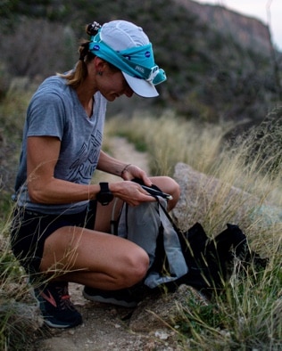 A woman packing her backpack