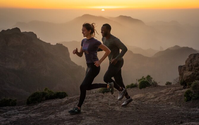 Two runners running in the mountains