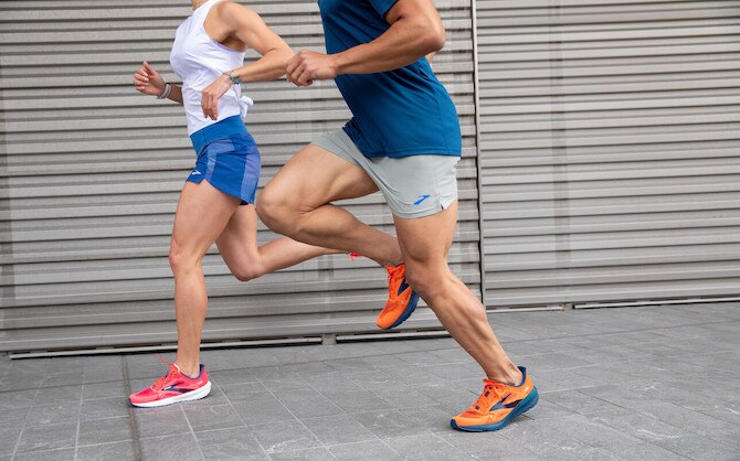 Low-angle show of two runners wearing running shoes