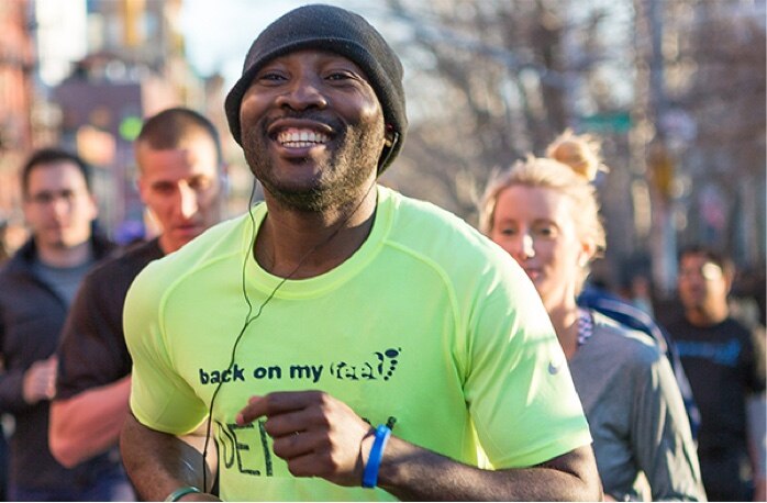 Man smiling while running.