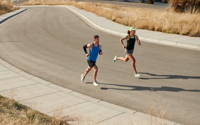 Two runners on an empty road