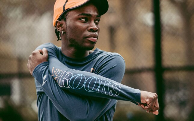 Runner stretching his right arm before his run