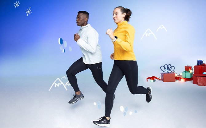 two people running with holiday gifts in background