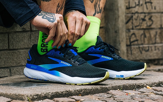 Close-up of someone's feet wearing the Ghost 16 with bright green socks