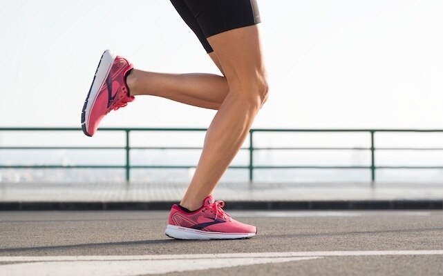 Side view of runner with pink shoes