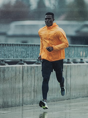 Runner running across a bridge.