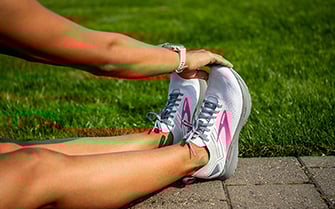 Women reaching for her toes wearing the Ricochet 3 shoes