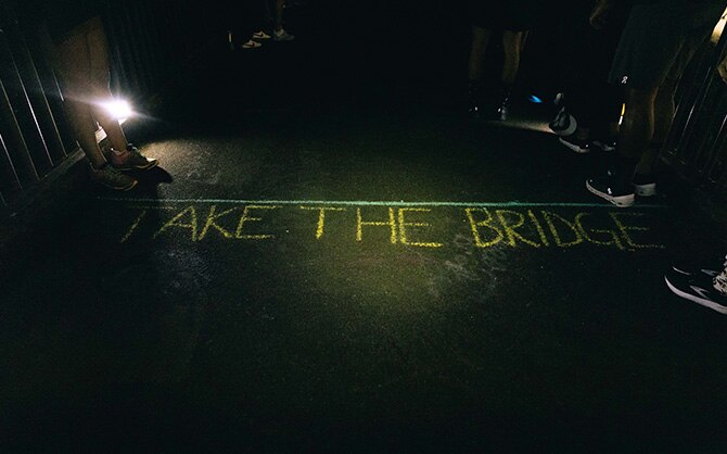 Runner headlamps illuminate the Take the Bridge 10K finish line. 