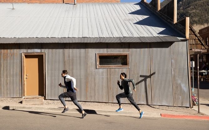 Two runners on a street in front of building