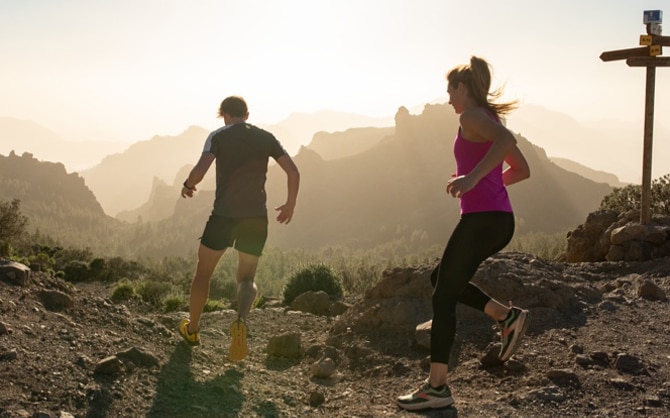Two runners running in the mountains