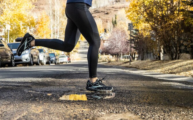Woman running across a road