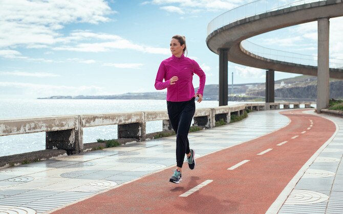 Woman running on a boardwalk track