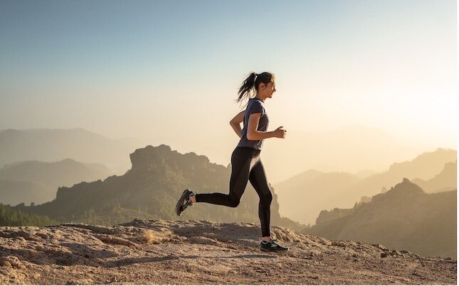 Close-up view of a runner wearing a pair of running shoes with arch support.