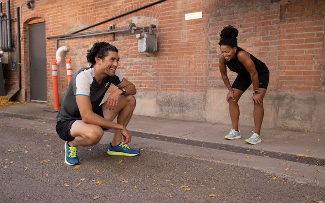Two runners crouching after a run