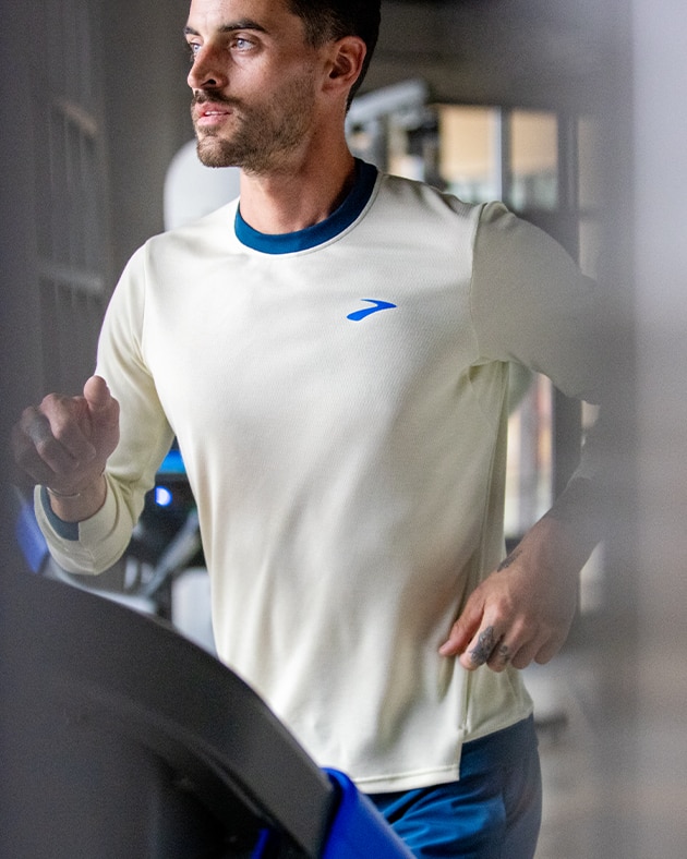 Side view of man running on a treadmill