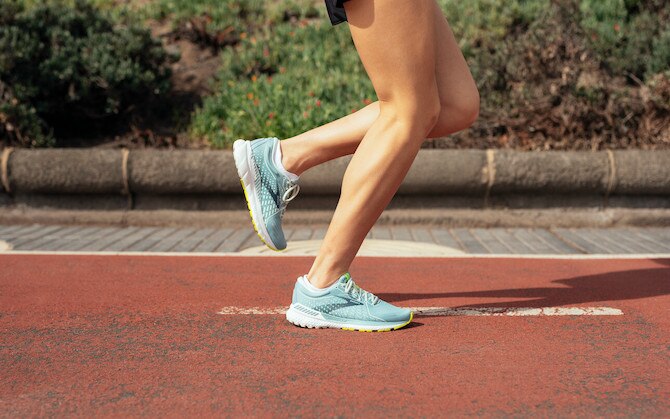 A close-up view of a runner's shins during their stride.