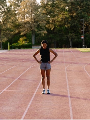 Woman standing alone in the middle of the track