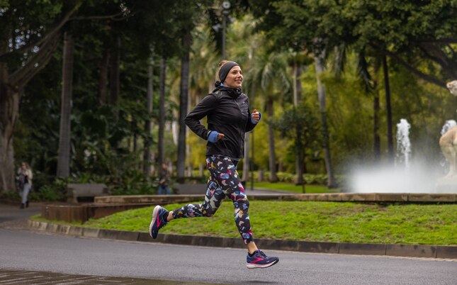 Two runners with their feet striking the ground