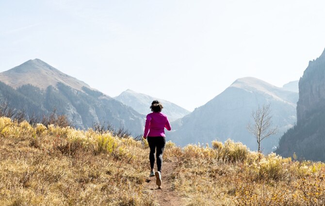A woman running on trail