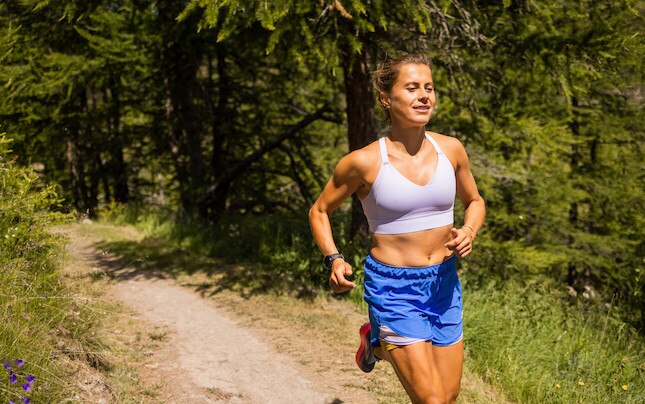 Women trail running in the woods