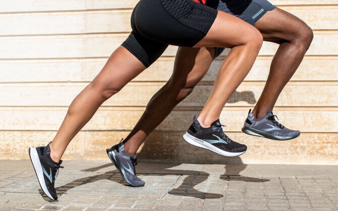 Two runners stride forward in unison