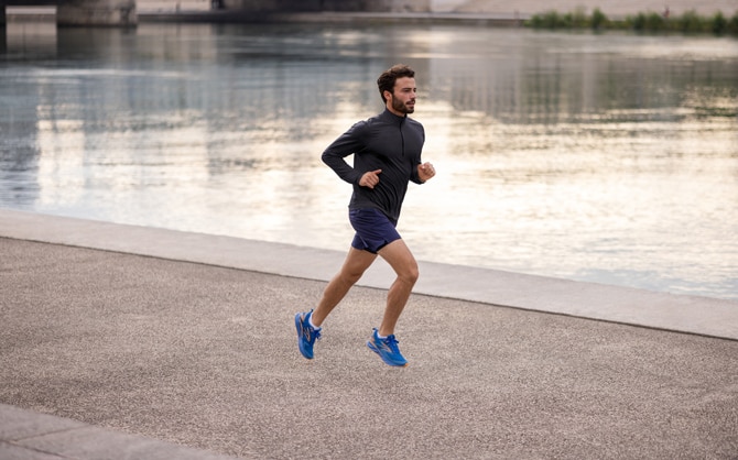 A male runner running to beat his average best  marathon time