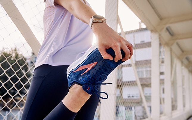Illustration of a woman asleep who has a thought bubble showing she’s dreaming of heart, smiley face, and peace sign icons.