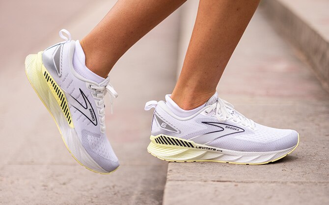 Two runners stride forward in unison