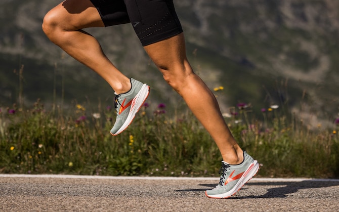 A low-angle shot of a runner pushing off mid-stride.