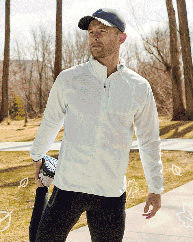 Man stretching in a white canopy jacket