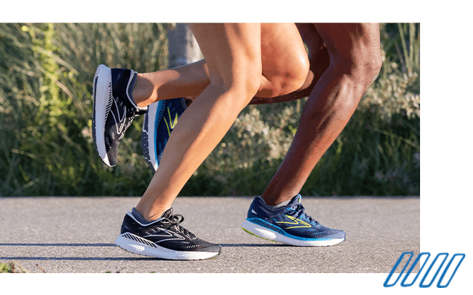 Close up photo of the legs of two runners wearing Brooks Adrenaline GTS shoes with GuideRails technology.