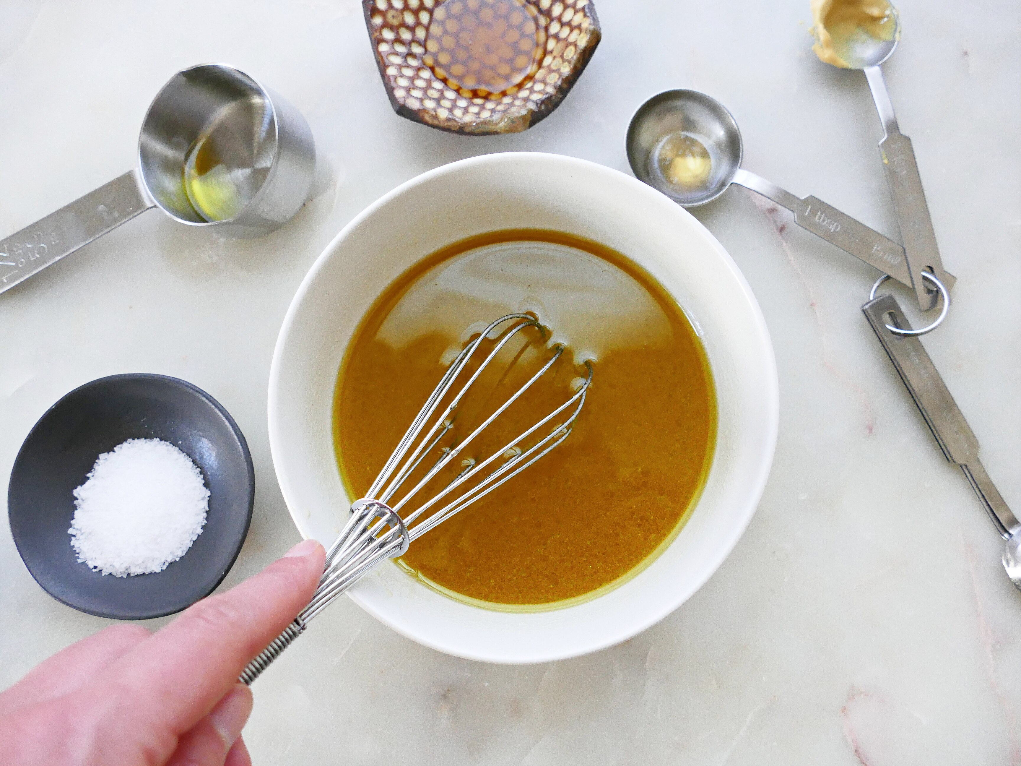 Un bol avec de la sauce et un fouet