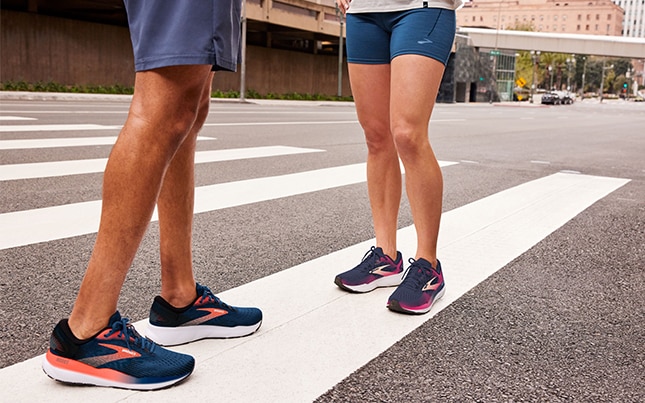 Two runners on a road crossing