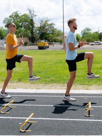 Two men doing warm-ups on the track