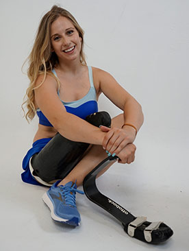 Woman crouching, showing her prosthetic leg