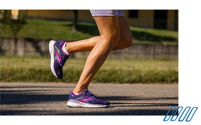 Close up photo of the legs of two runners wearing Brooks Adrenaline GTS shoes with GuideRails technology. 