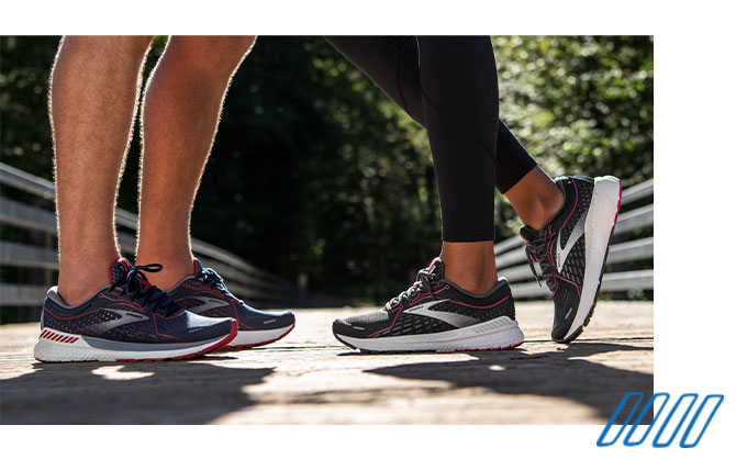 Close up photo of the legs of two runners wearing Brooks Adrenaline GTS shoes with GuideRails technology. 