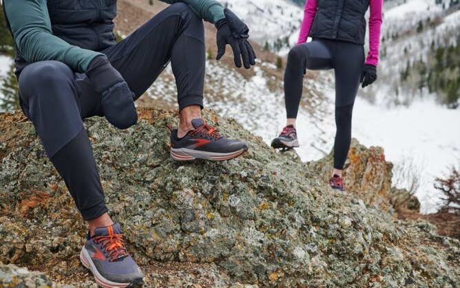 Runners sitting on a rock