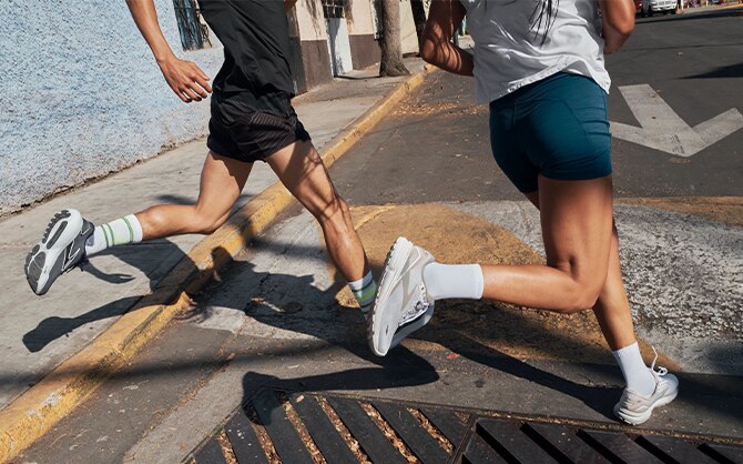 Two runners in an urban landscape wearing Ghost 15s and Glycerin 21s